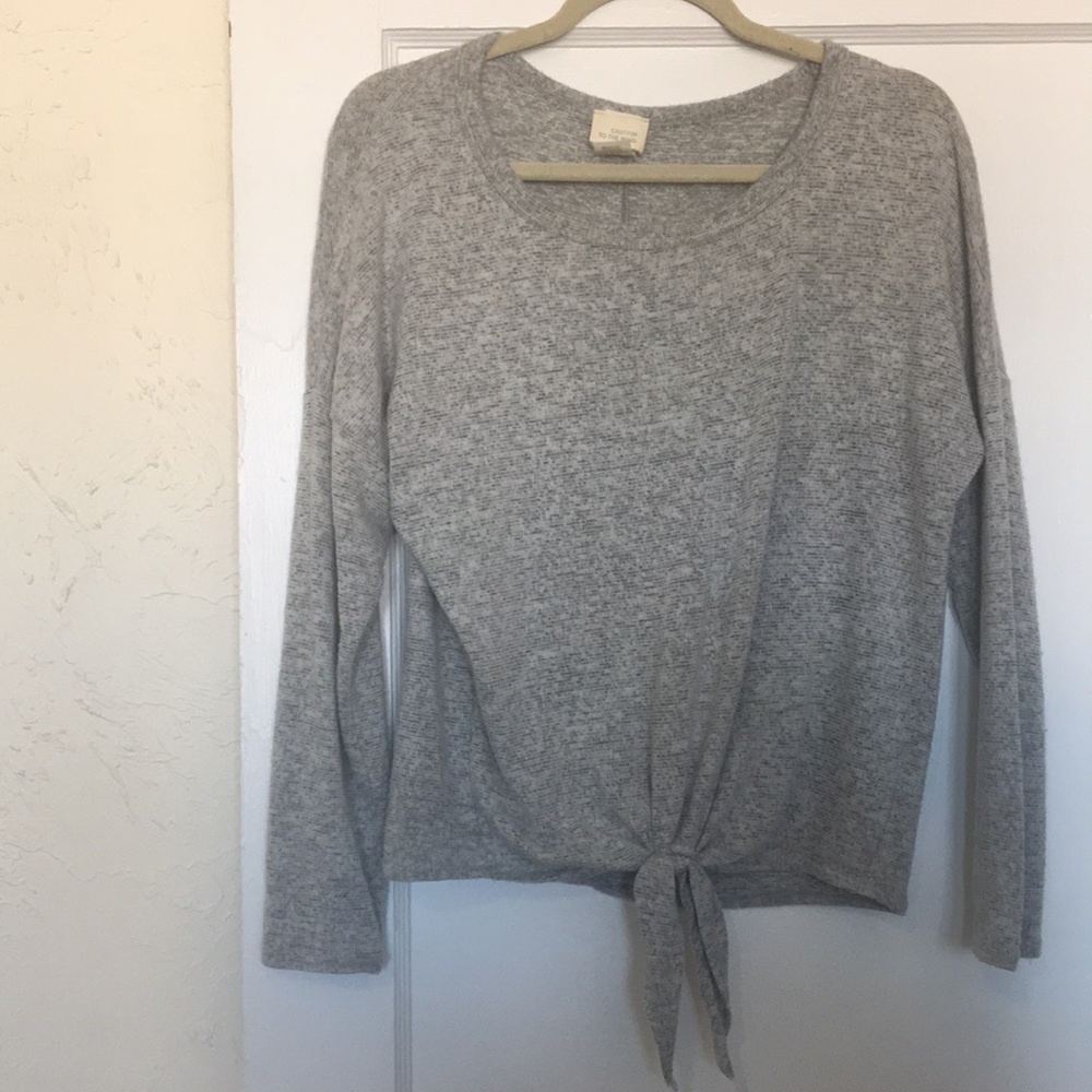 Soft grey sweater with tie detail.